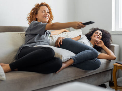 Women watching TV after being identified by a campaign with high market research data quality