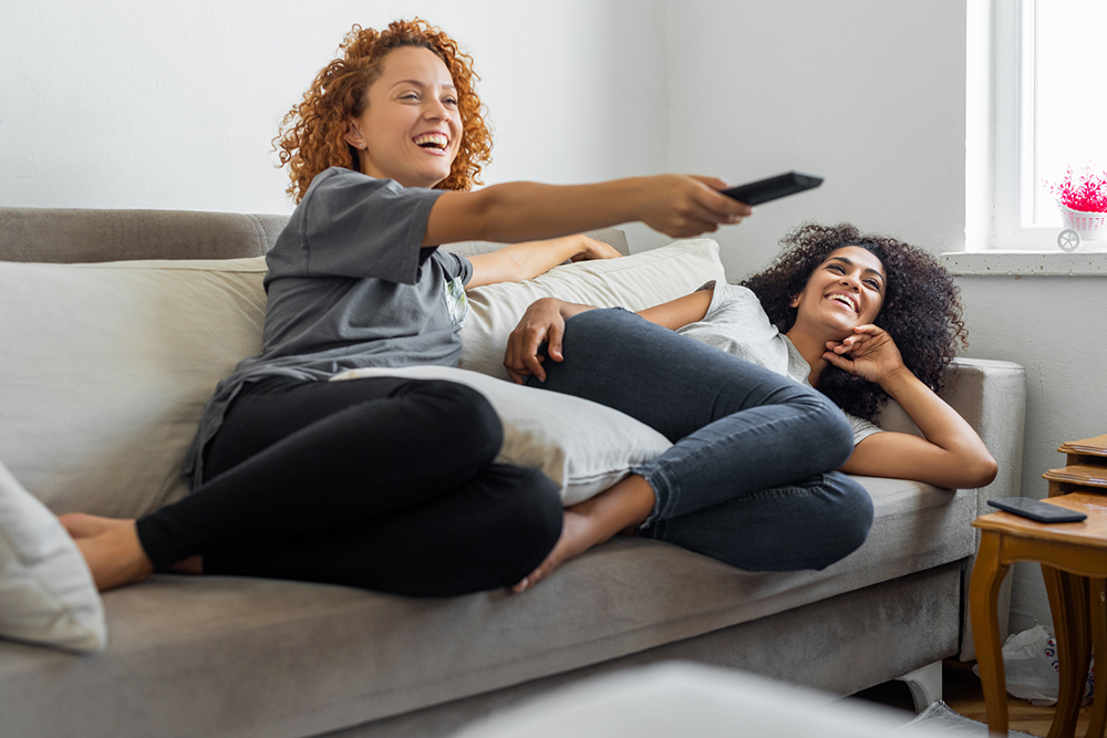 Women watching TV after being identified by a campaign with high market research data quality