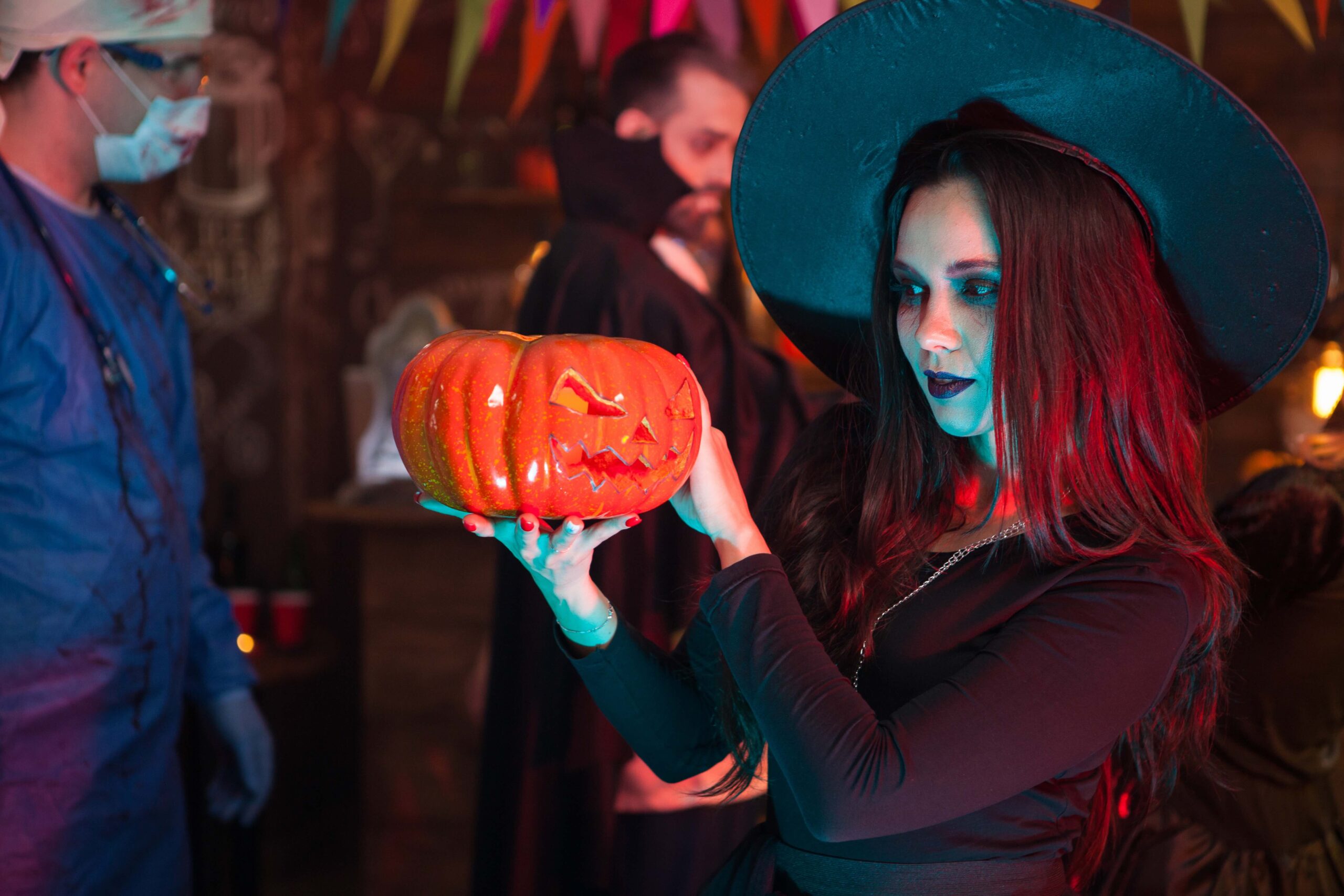 woman-holding-jack-o-lantern-at-halloween-party-2026-03-19-02-02-17-utc